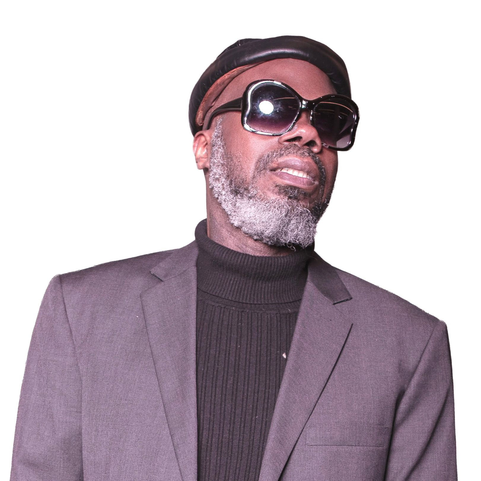 Dance in the Dark™: Groove to Give Festival DJ Charley Mystro, Groove to Give Festival DJ, wearing sunglasses, a dark blazer and black turtleneck.