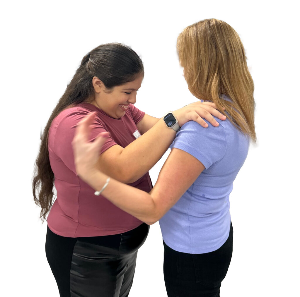 A young blind woman learning  a partnered dance movement through guided tactile feedback while connecting to her partner and verbal\body awareness instruction.