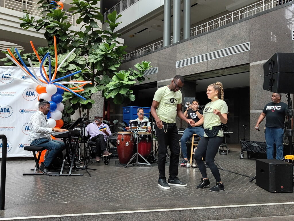We Can Dance instructors, Samy and Nikki Vez, dancing together in front of a live band at the ADA 36 celebration.