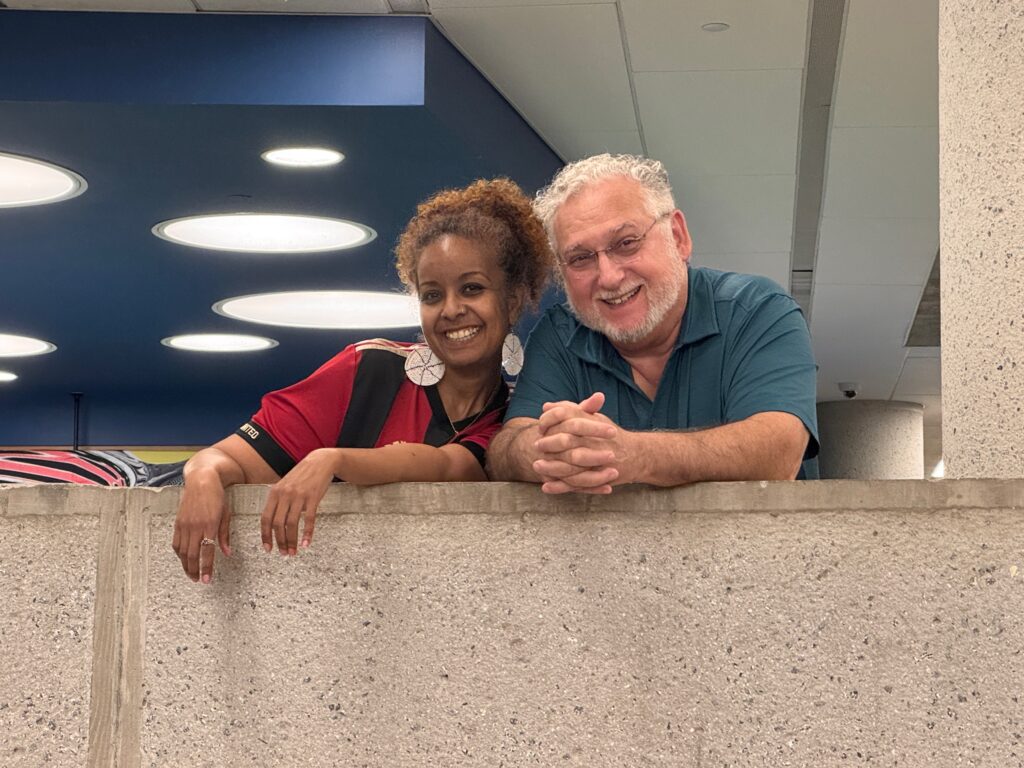 Two smiling volunteers, Mackie and Art, posing together during the World Cup Edition.