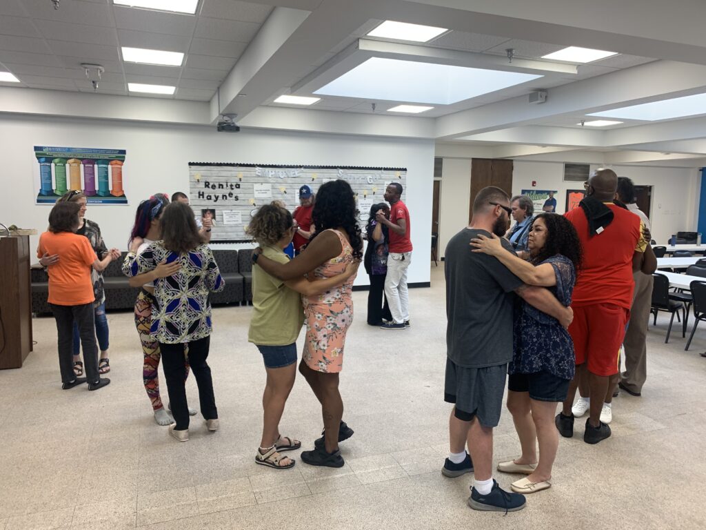 Several pairs practice partner dancing together during the Dance in the Dark workshop.